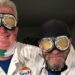 Two men boiler suits with flying goggles